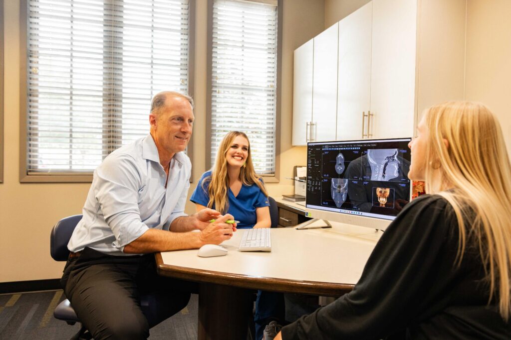 Patient completing orthodontic paperwork during consultation at Jensen Orthodontic Arts